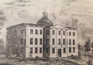 Early sketch of the Tuscaloosa Capitol Building. The dome was elevated in such a way to be seen from across the Black Warrior River, which was a source of great traffic to the area. The structure made a statement both about Tuscaloosa's importance and the long reach of Western government and philosophy. From Amalia K. Amaki's Tuscaloosa.  13